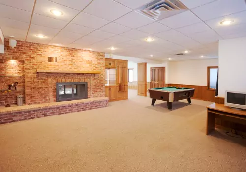 A large carpeted basement after Basement Finishing in Washington IL